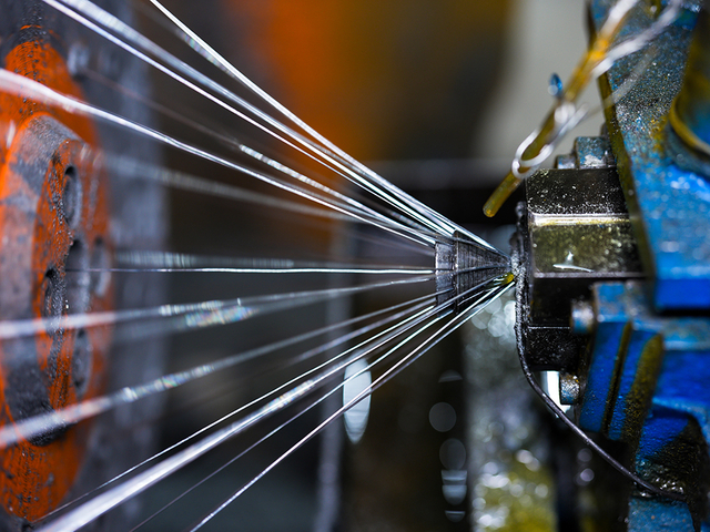 Steel wire rope factory interior with production lines and workers ensuring strict quality control