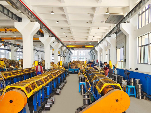 Green industrial equipment in steel wire rope factory supporting specialized production stages